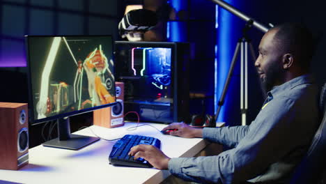 man having fun by playing videogames on gaming pc at computer desk