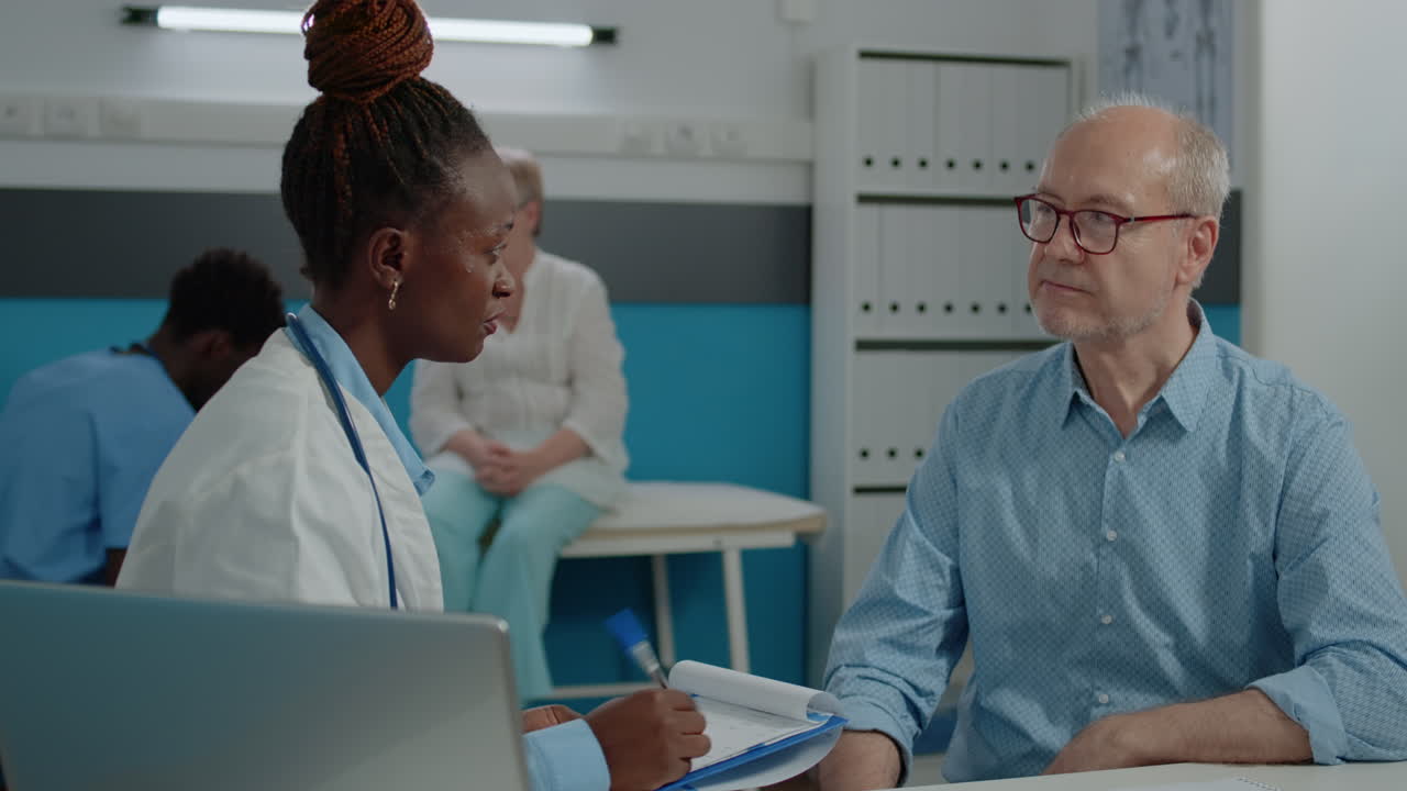 Doctor checking on elder patient healthcare in medical cabinet