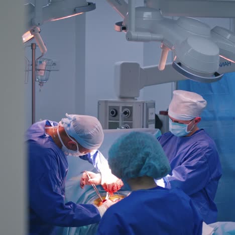 surgeons making operation. teamwork of doctors in medical uniform perform a surgery in the modern operating room.