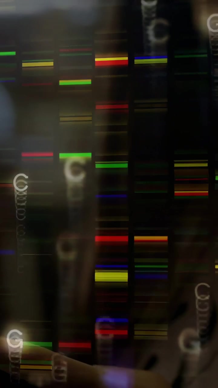 Vertical video: Woman touching glossy panel, sparking dense color bars and DNA letters for tech