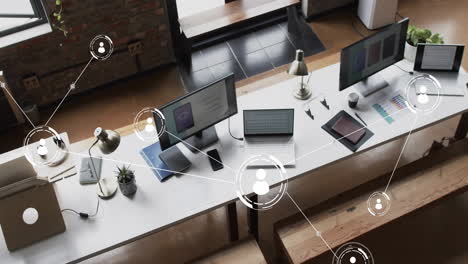 animation of digital icons with connections over computers on desks in office