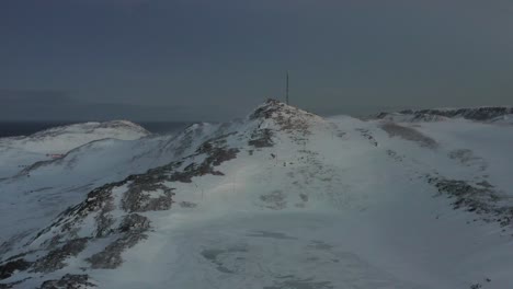 shot of the no mans land in northern europe during winter, showing a windy frozen tundra. aerial shot.