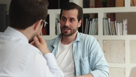 serious advisor consulting client making offer at meeting in office