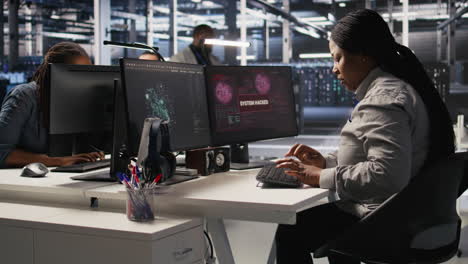 vertical video panicked system administrator in data center reacting to spyware warning