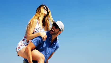 Couple-enjoying-together-at-beach