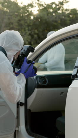 a crime scene investigator taking photos of a car