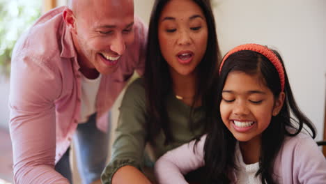 parents, girl child and tablet for games