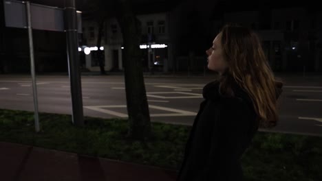 girl taking a walk in the city at night time slow motion