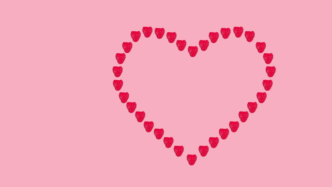 many fresh ripe raspberry in the shape of a heart animated on a pink background close-up. seamless looping of realistic 3d food.
