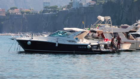 tourists on a boat near sorrento cliffs