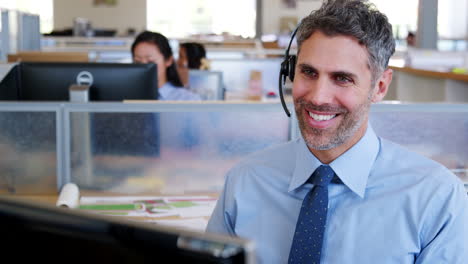 Middle-aged-white-man-working-at-a-call-centre,-close-up