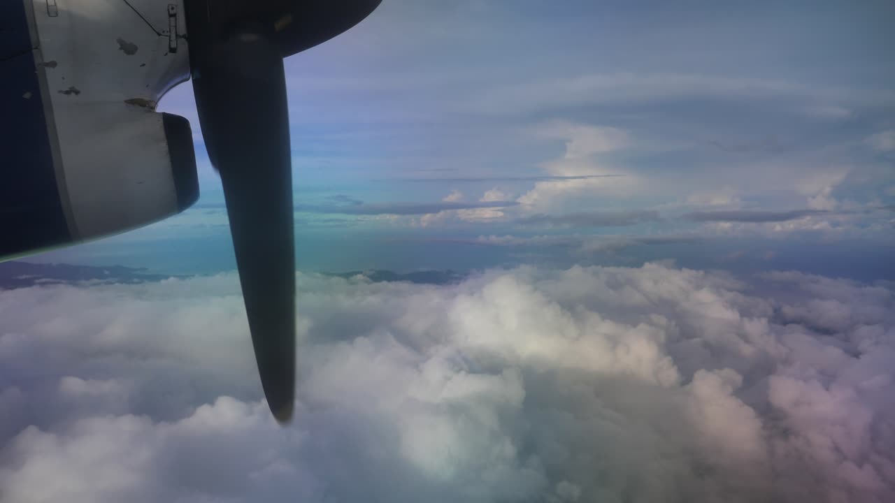 View from a plane - prppeller and clouds over the pacific ocean and the solomon islands