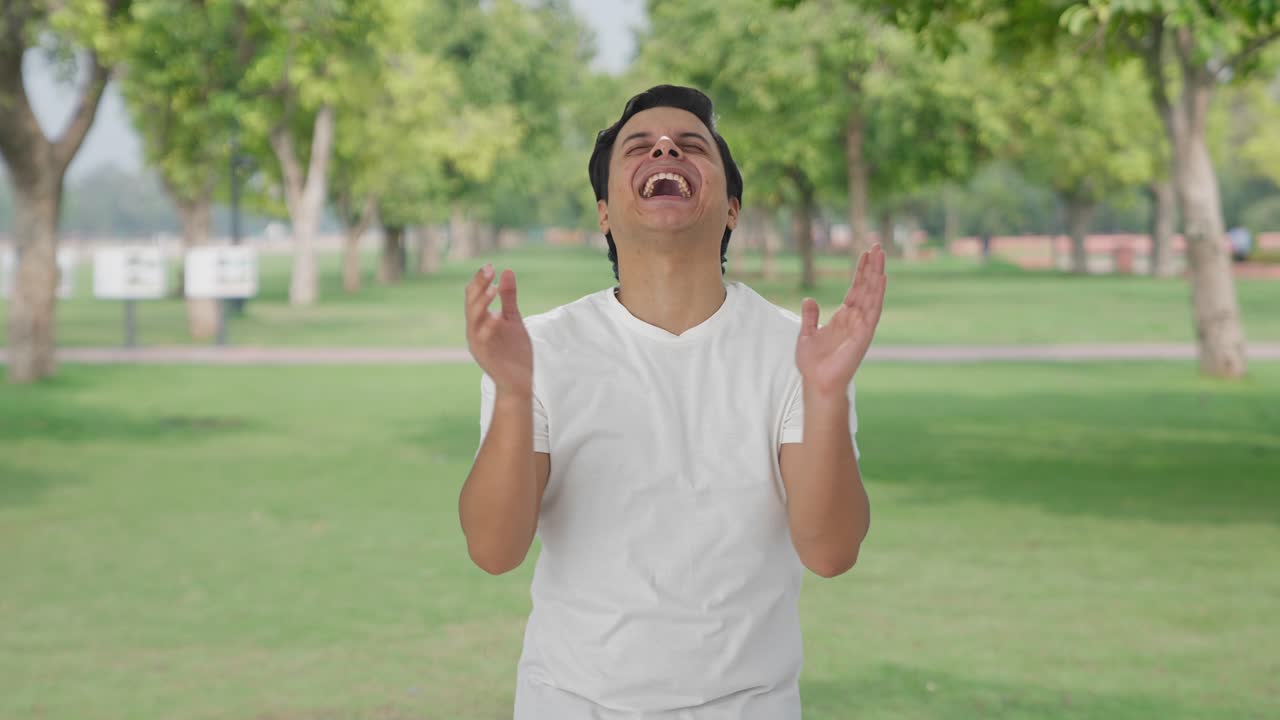 인도인 남자가 누군가에게 웃고 있습니다.