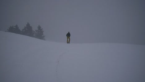 woman-hiking-through-blizzard