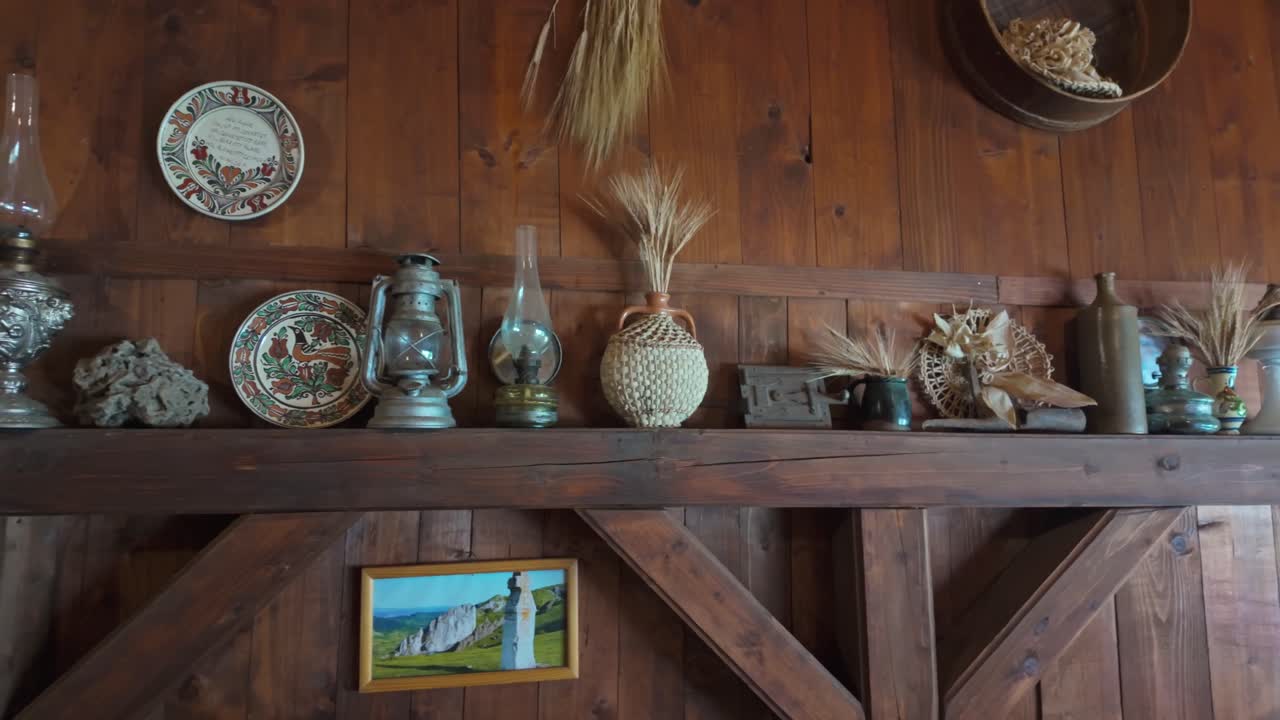 Interior design of a restaurant terrace with a collection of old lamps and handicrafts on a wooden beam in Torockó, Romania