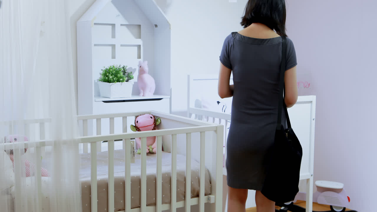 Pregnant woman shopping for the baby cot 4k