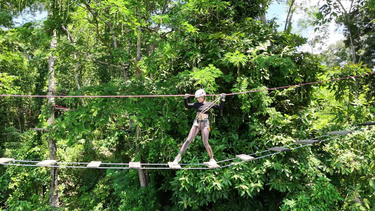 People enjoying a treetop adventure park activity