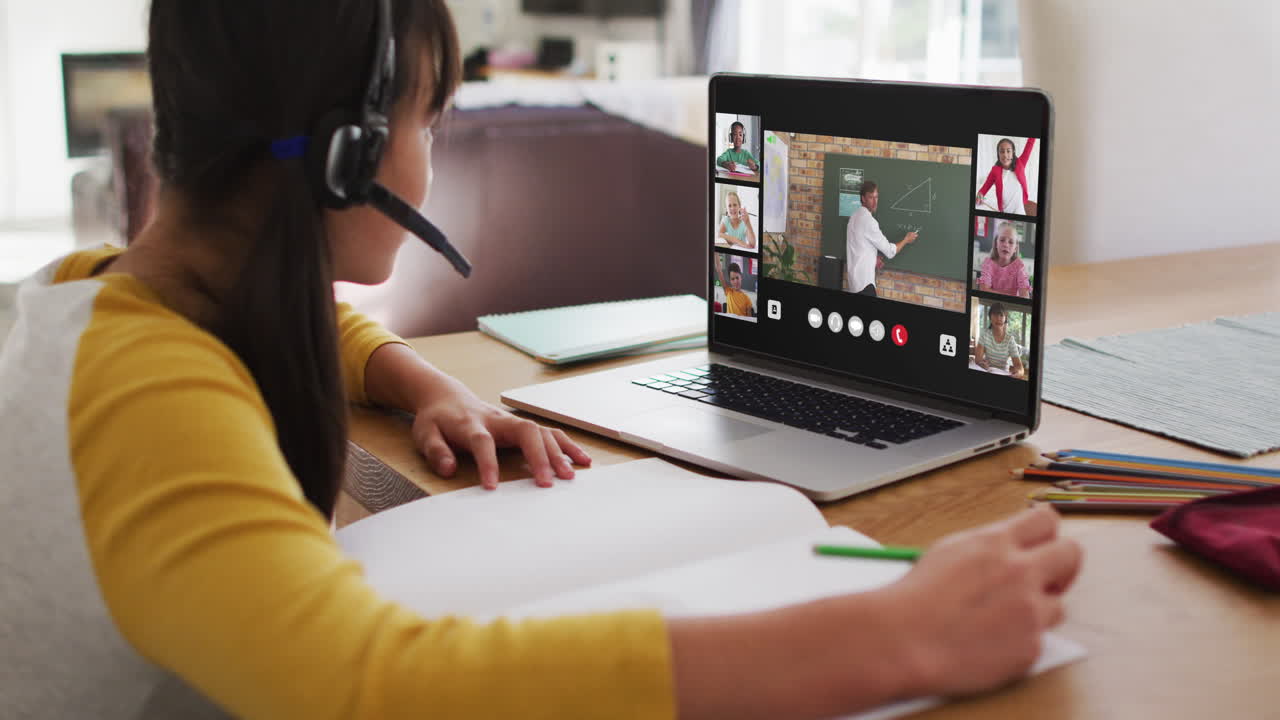 Schoolgirl using laptop for online lesson at home, with diverse teacher and class on screen