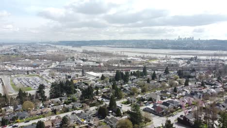 Drone-Footage-of-a-suburb-on-a-hill-with-a-river-background---mid-day