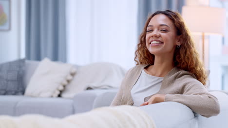 una chica feliz, despreocupada y sonriente relajándose en el sofá