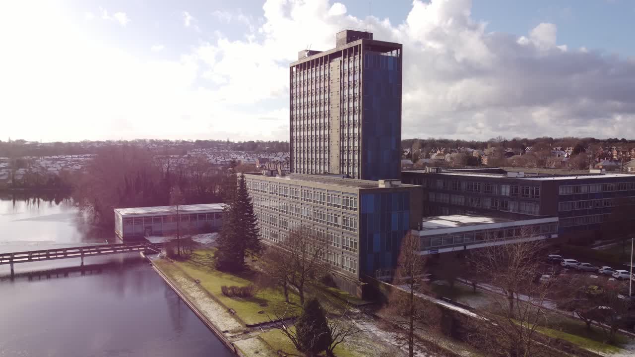 Aerial view Pilkington's glass head office and gardens, a modern blue high-rise with shared office space