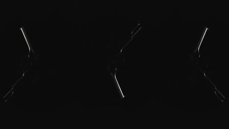 Three pistols on the dark background and in blinking lights are falling in slowmotion
