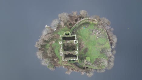 aerial view of mcdermott castle ruins on an island in lough key, roscommon, ireland, with surrounding water