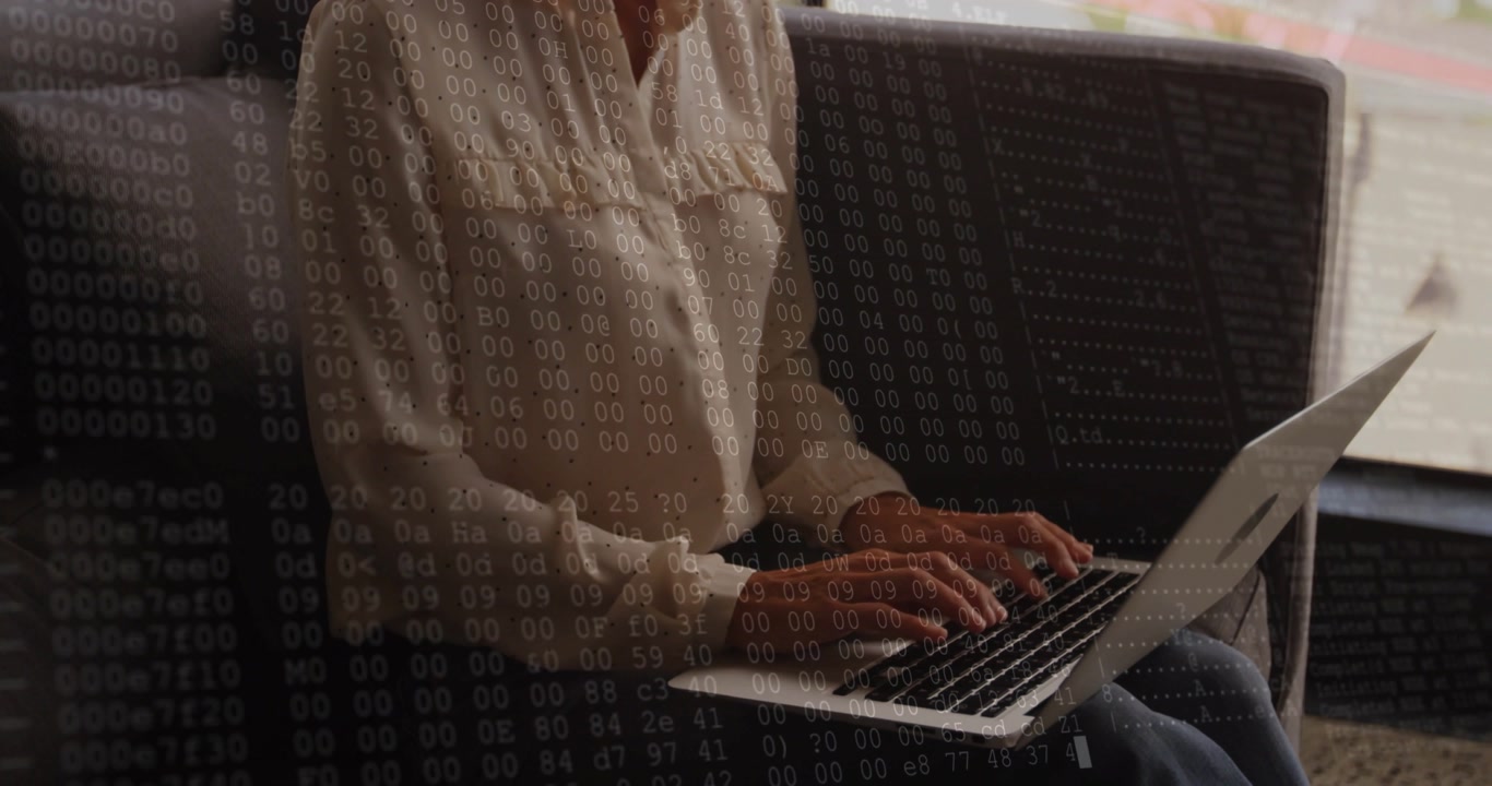 Typing woman in light blouse and jeans, working on laptop on couch at home numeric overlay