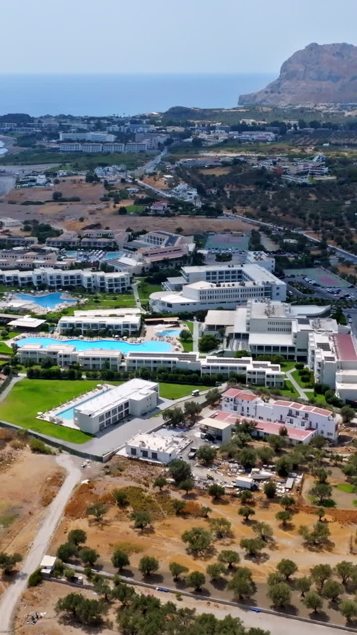 Vertical drone shot of all-inclusive hotels, sunny, summer day in Rhodes, Greece