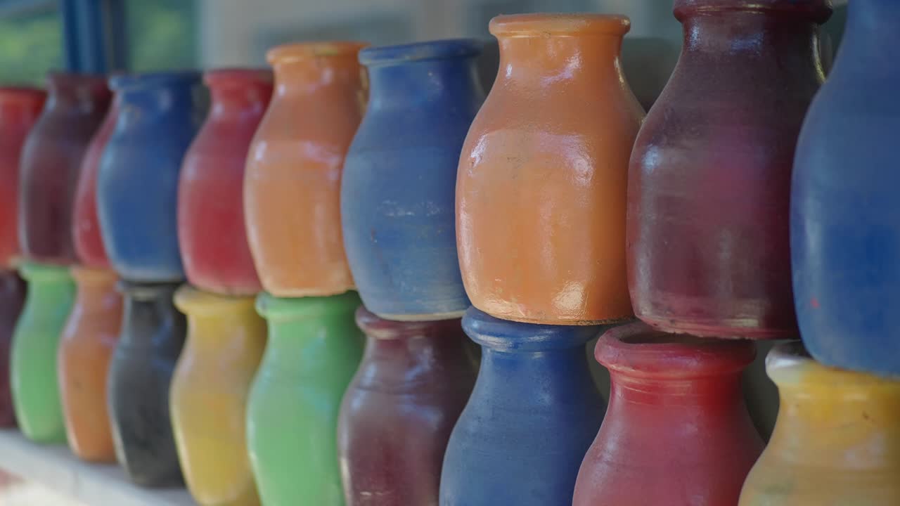 Colorful Row of Small Pottery Jugs