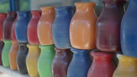 colorful row of small pottery jugs