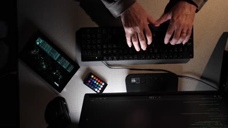 Hacker-types-as-the-overhead-camera-moves-across-their-work-area