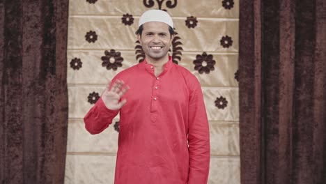 Muslim-man-waving-hello-to-the-camera