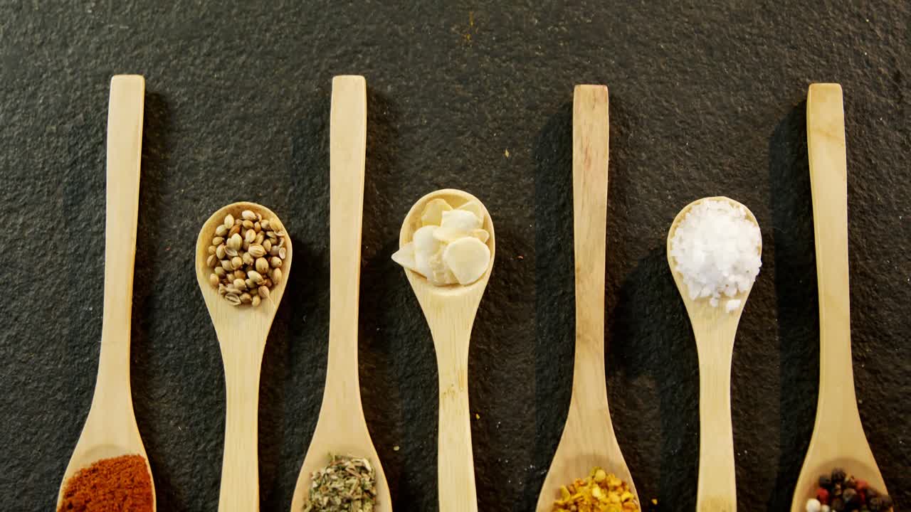 Various spices arranged in a spoon 4k