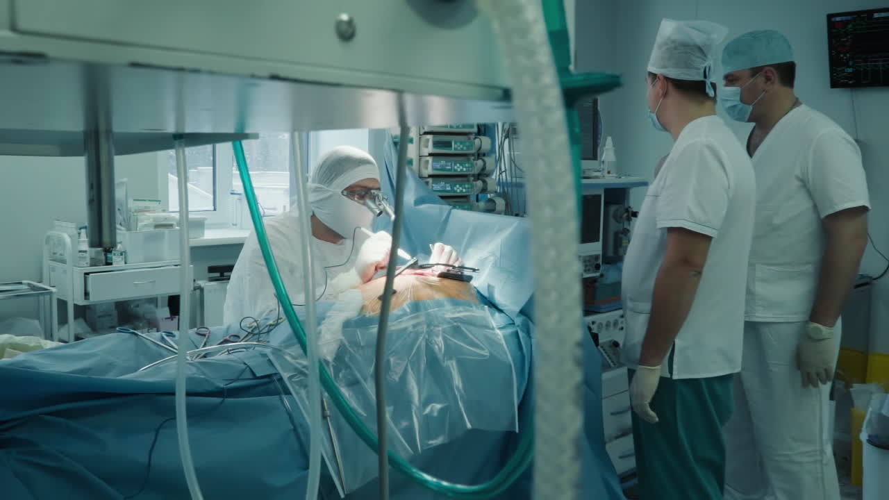 Cardio surgeons work with patient in room. Doctor with assistants team work together during coronary artery bypass surgery in clinic. Heart care