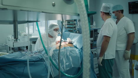 cardio surgeons work with patient in room. doctor with assistants team work together during coronary artery bypass surgery in clinic. heart care