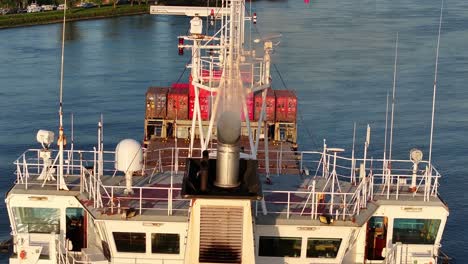 close-up of marjatta boat bridge and containers cruising through a river in barendrecht