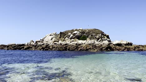 imágenes estáticas de un peñasco rodeado de agua clara con un fondo marino claro y oscuro