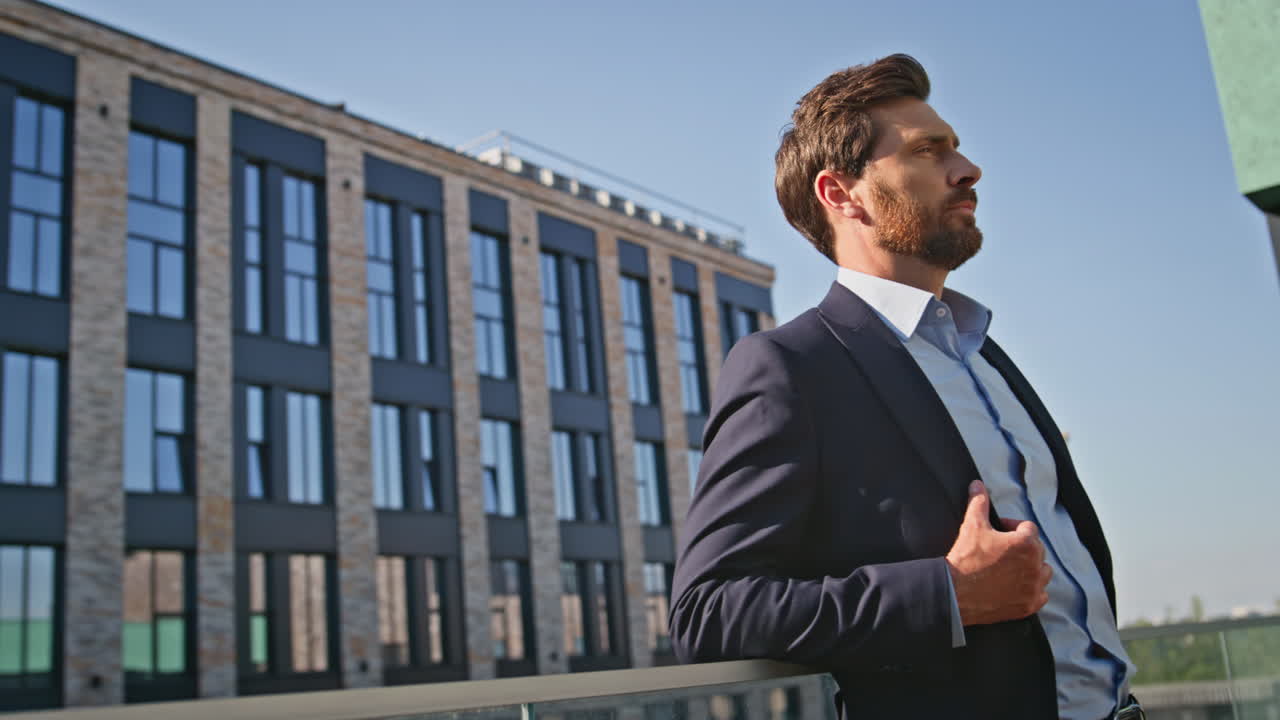 Serious businessman thinking project standing at sunny office district closeup