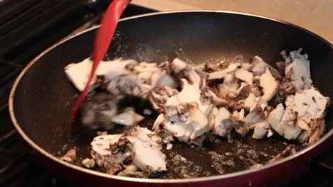 close up of sauteing maitake mushrooms in butter and skillet in a tiny home kitchen