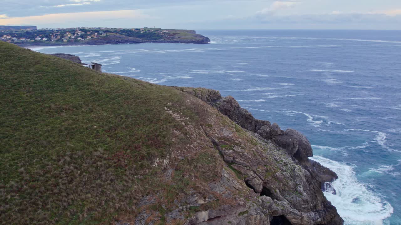 Drone footage shows the beautiful view of the Cantabrian island of Isla's shoreline meeting the deep blue sea
