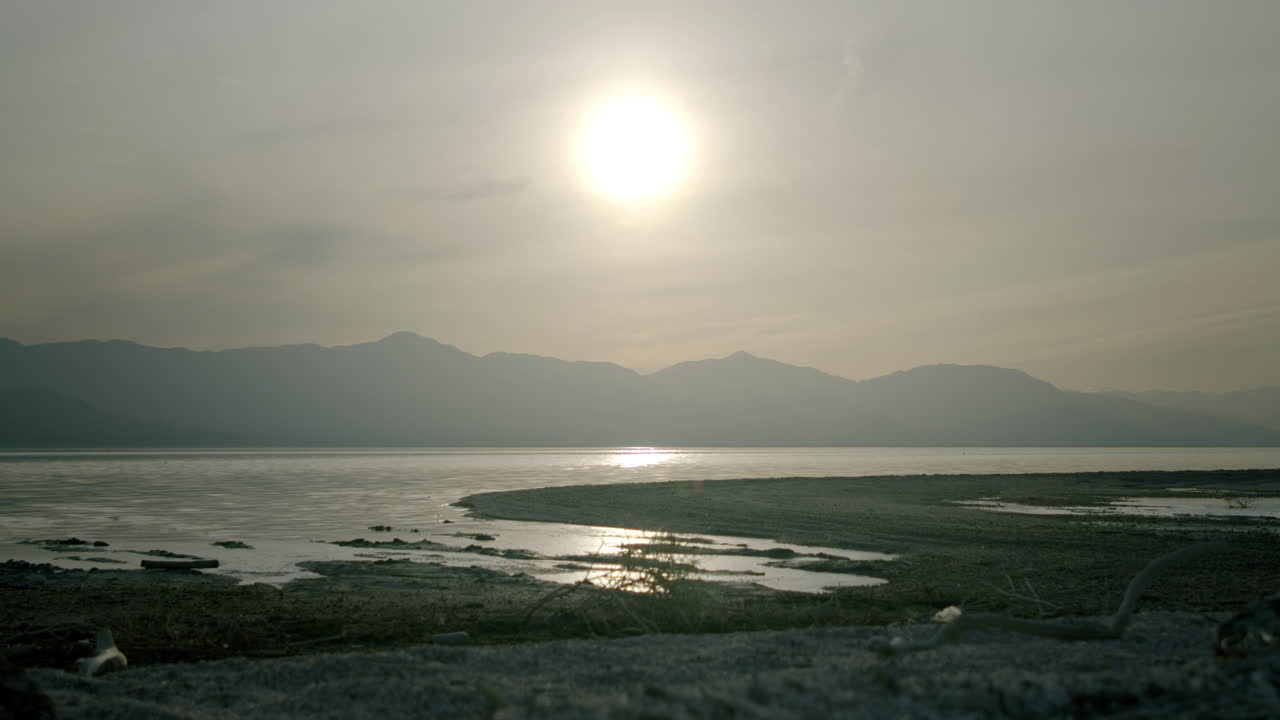 Tranquil lake landscape with mountains at sunrise