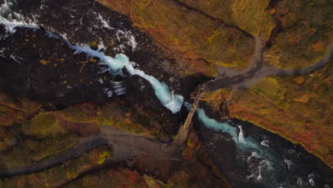 spectacular blue glacial brúará river flowing below a bridge in iceland