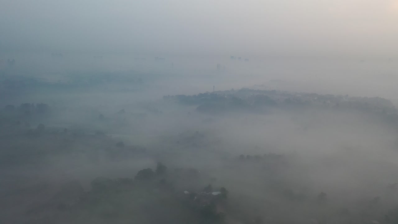 Misty Sunrise Over a Town