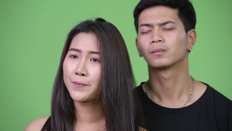 young asian couple thinking together while looking worried