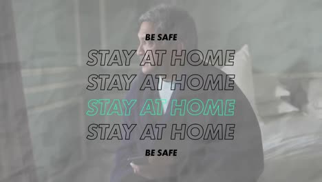 Animation-of-stay-at-home-be-safe-text-over-worried-senior-man-at-home