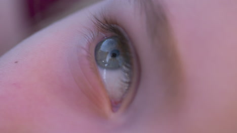 slow motion macro of the beautiful eyes of a little girl with sectoral heterochromia