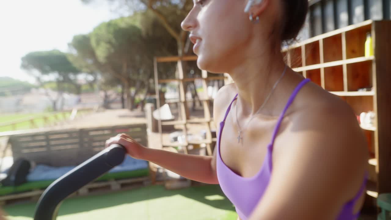 A woman exercising outdoors with earbuds