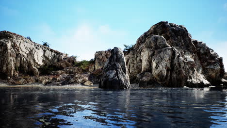 Tropical-rock-island-against-blue-sky-and-sea