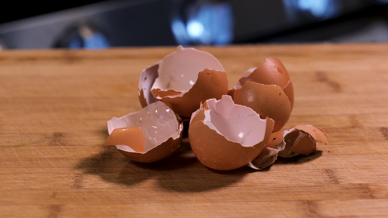 Eggshells on a cutting board in a kitchen